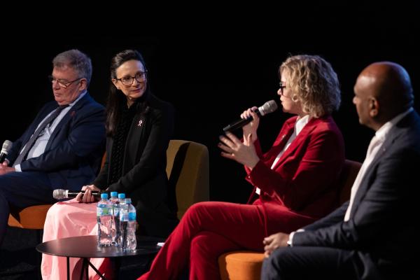 4 panelists in discussion at an event