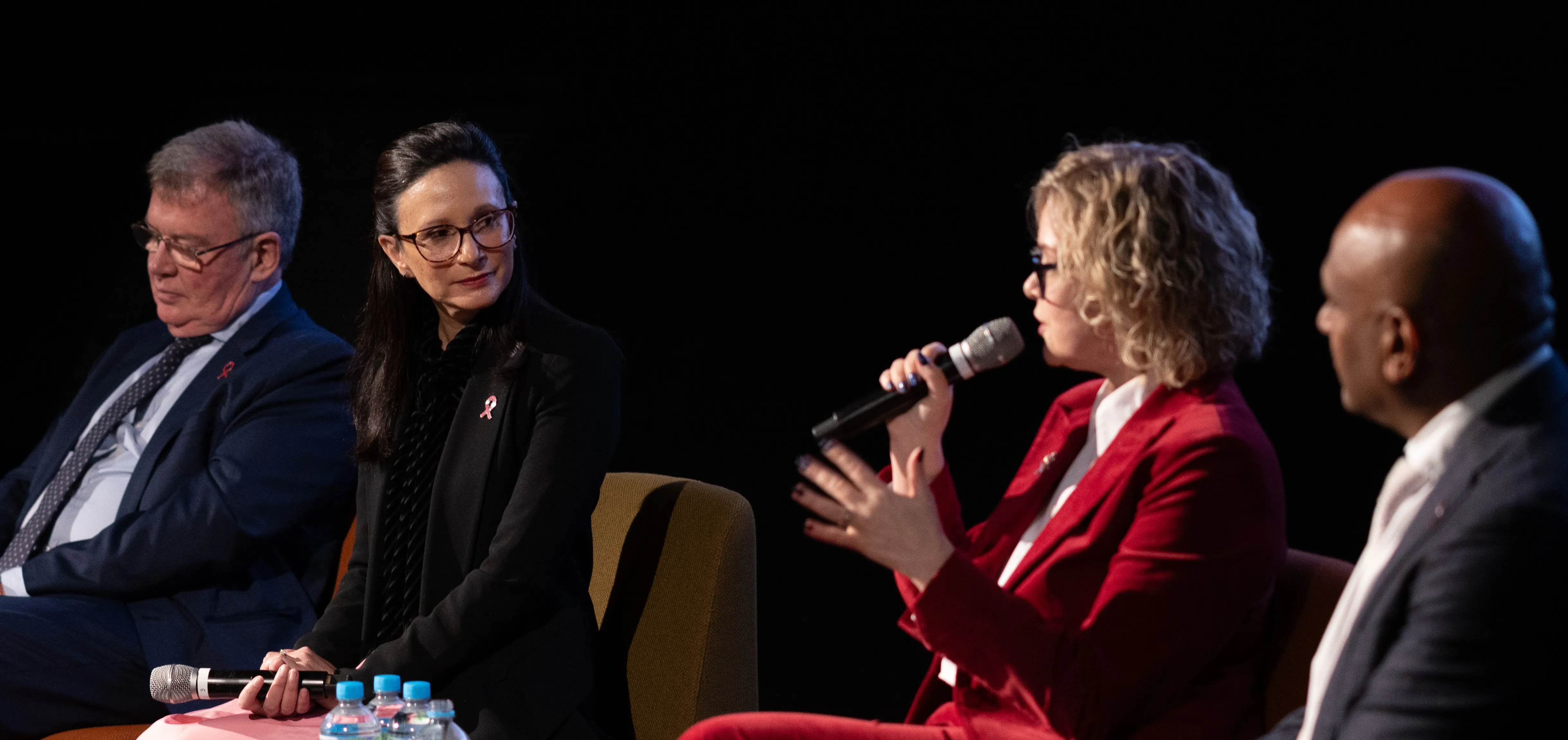 4 panelists in discussion at an event